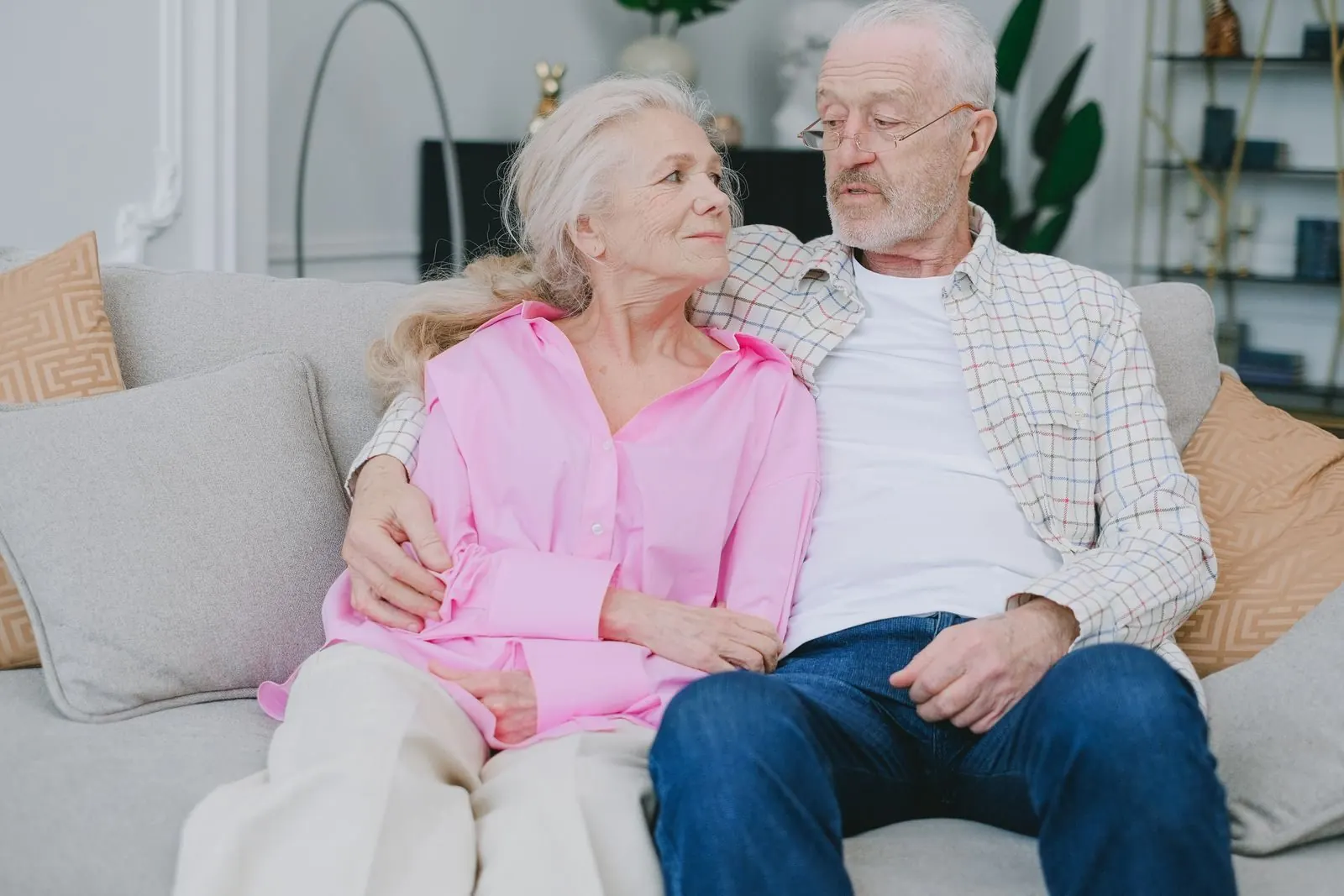 An older couple relaxing together on the sofa at home