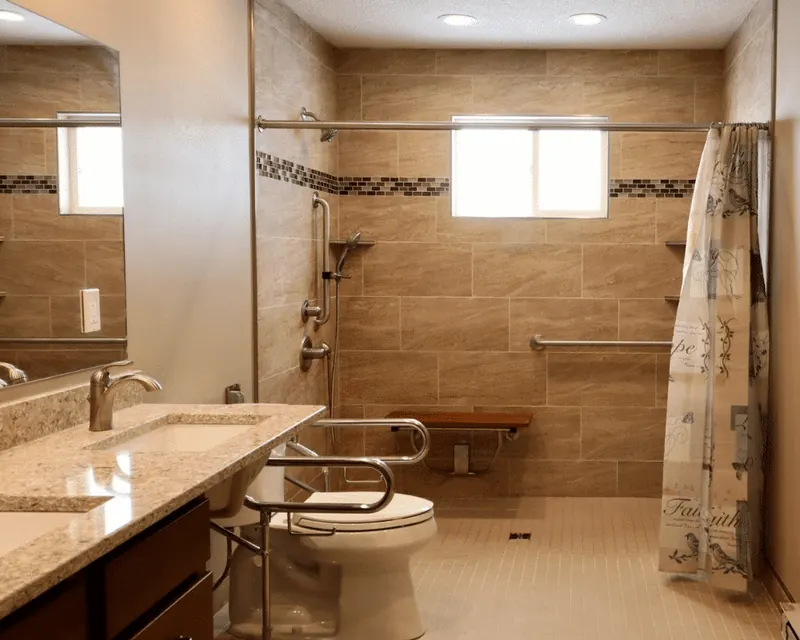 A bathroom with an open shower entry and support rails