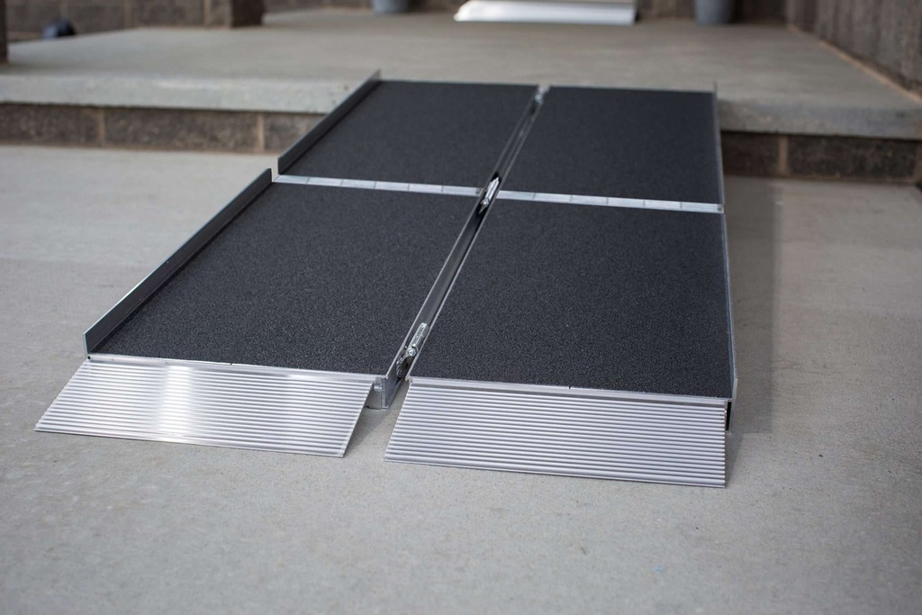 Four ramp panels joined by lengthwise hinges, with ribbed transition plates on concrete