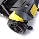 Solid rear tire and anti-tip wheel at the back corner of a yellow Transformer