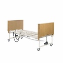 Side view of the flat bed with both wood-finish covered bed ends fitted onto the white frame