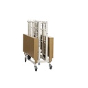 Bed folded and nested for storage, the sections stacked upright on the braked castors