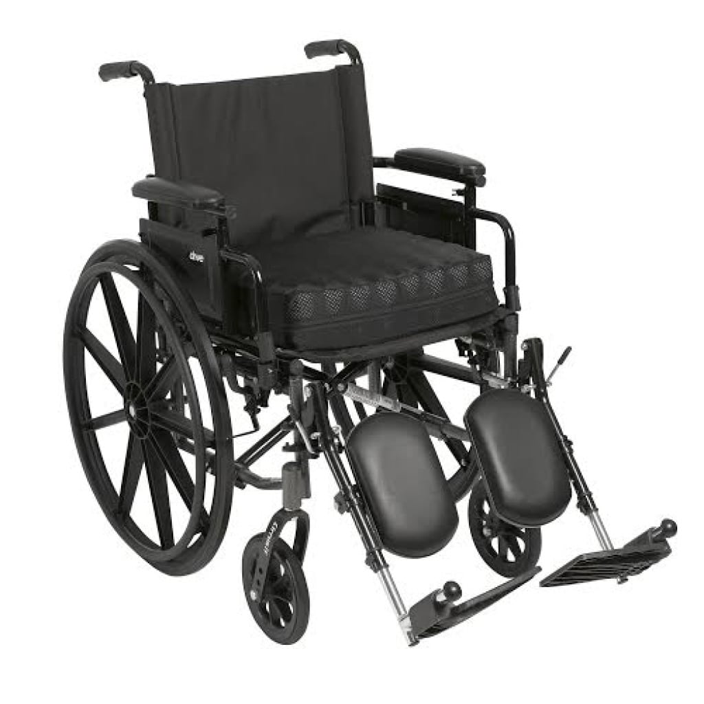 Balanced Aire cushion in its black cover on the seat of a manual wheelchair with elevating leg rests
