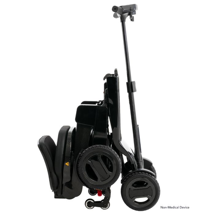 Go-Go Carbon folded and standing, with the telescoping tiller raised to roll it along