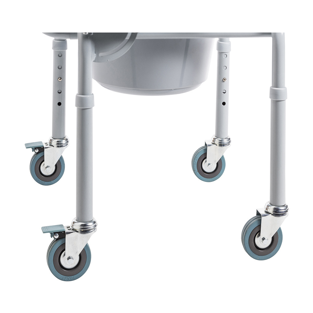 Close-up of the four swivel casters, two with brake levers, and the leg holes