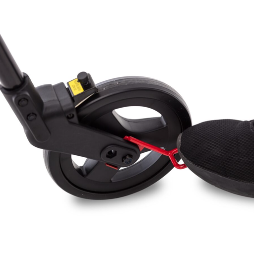A shoe pressing the neXus curb climber accessory loop on the rollator's rear wheel