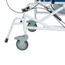 Close-up of a front caster with its lock lever and the anti-tip bar