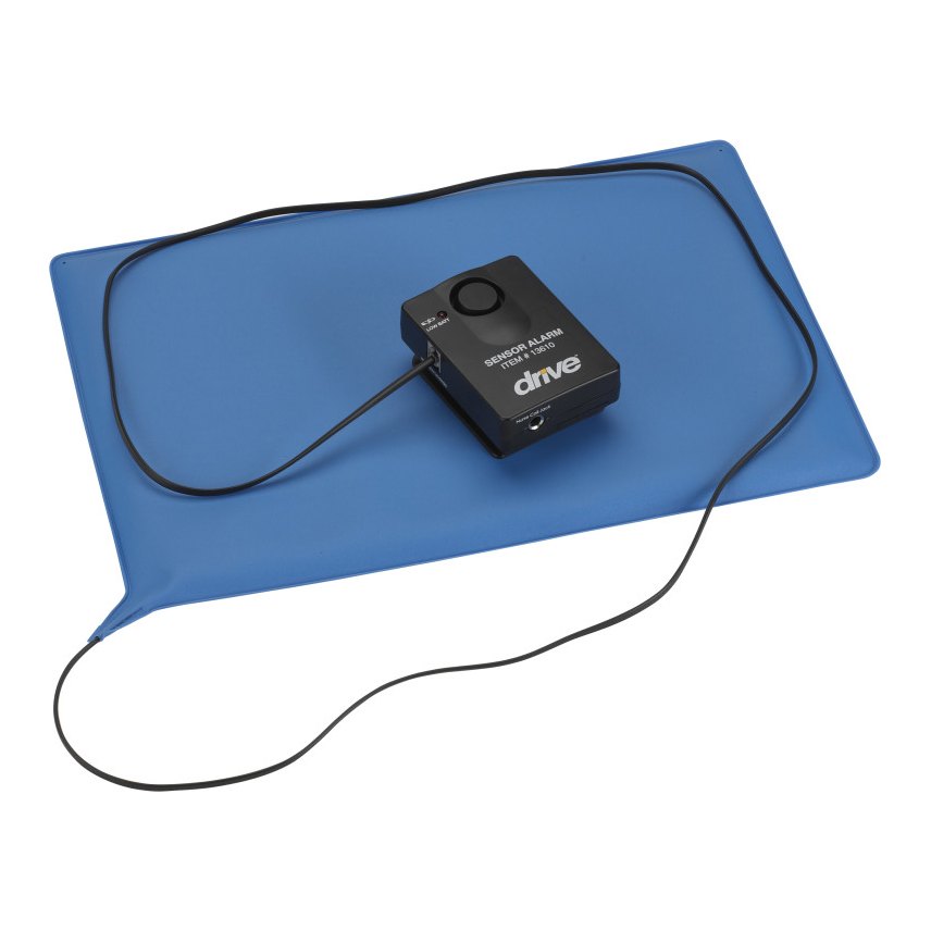 Black alarm box resting on the blue chair-size sensor pad, with the pad cord looped around it