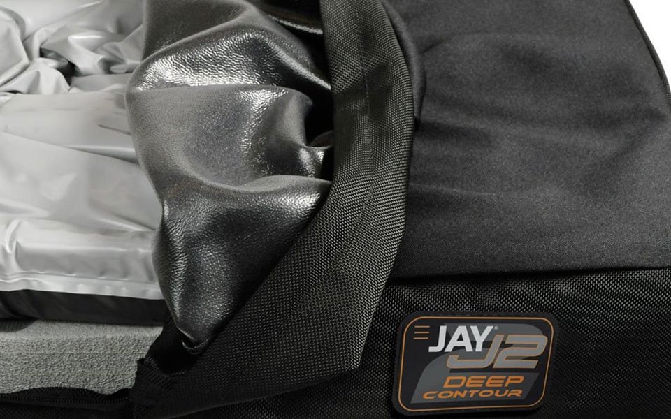 Corner of the J2 Deep Contour cover peeled back over a moisture-resistant layer, with the fluid pad inside