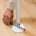 Hand turning a screwdriver through the jackscrew at the base to press the pole up to the ceiling