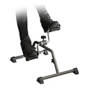 Two feet in shoes held by the pedal straps of the Drive peddler, mid-stroke
