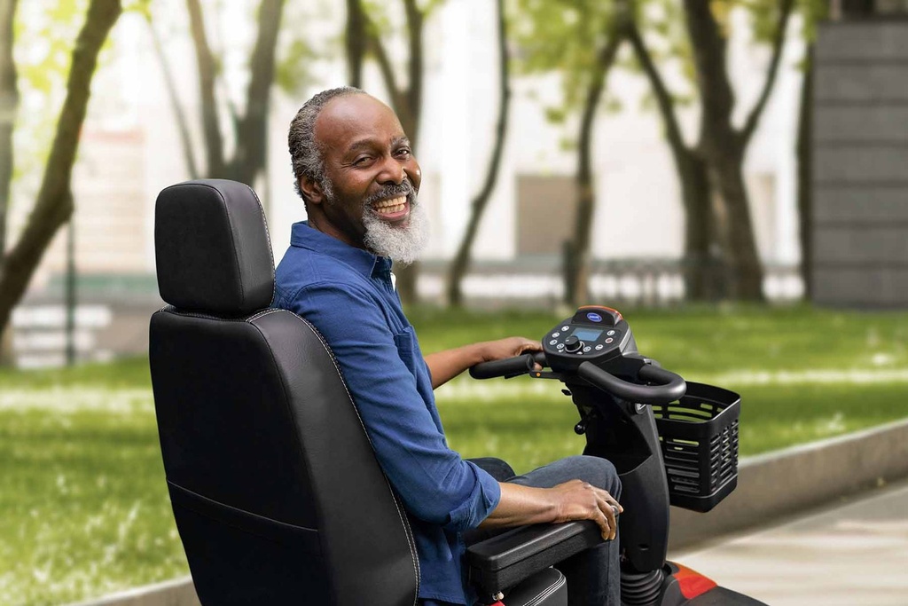 Rider in the Comet Pro's high-back seat with the LCD console and delta handlebar in view