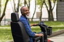 Rider in the Comet Pro's high-back seat with the LCD console and delta handlebar in view