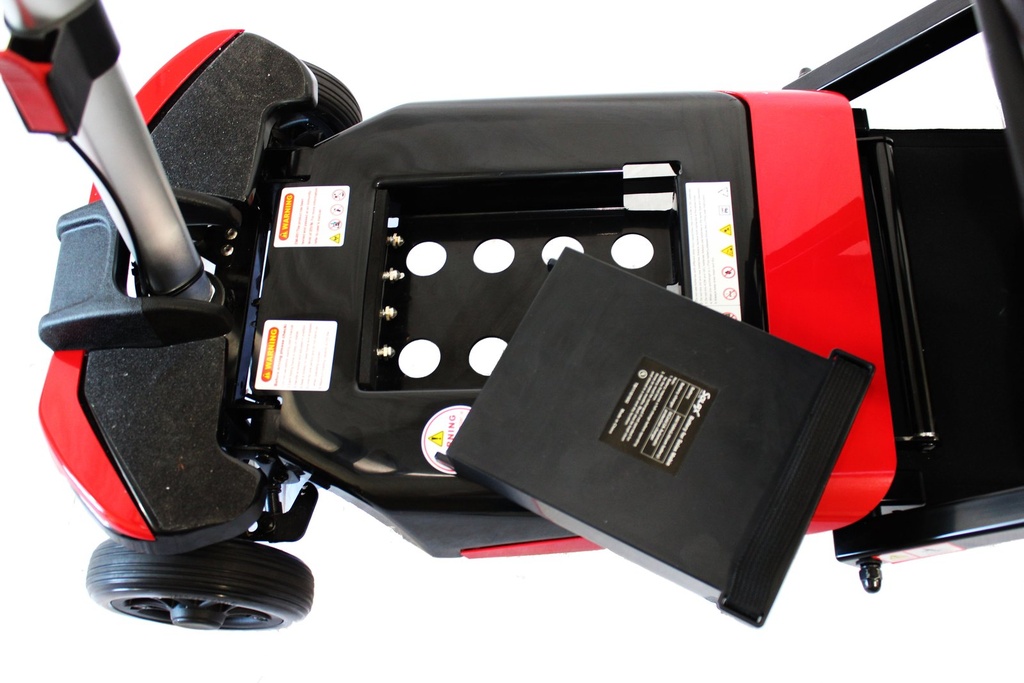 Lithium-ion battery lifting out of its compartment in the deck of a red Transformer
