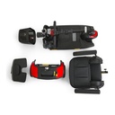 The scooter in its five travel pieces: basket, front frame with folded tiller, battery pack, rear section, seat