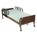 Example hospital bed with brown end panels, half rails raised and a pale green mattress