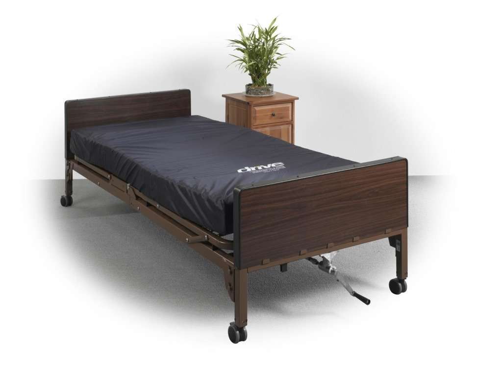 Example hospital bed with a dark blue mattress, beside a night table