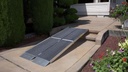 Trifold ramp set up over two concrete steps to a patio