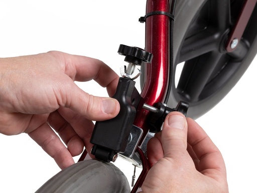 Black neXus slow down brake clipped onto the rear wheel fork of a Human Care rollator
