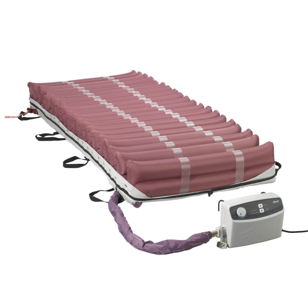 Med-Aire 8 mattress with its cover rolled back over the pink air cells and the pump at the foot
