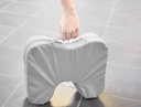 The covered FootStool 8090 carried by its handle on a tiled floor