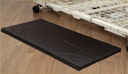 Joerns Comfort Matt floor pad 550132-CC on a wood floor beside a metal bed frame