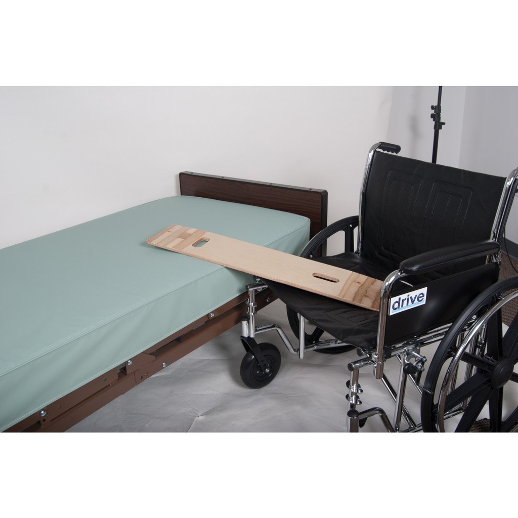 A wider view of the board reaching from the wheelchair to the bed