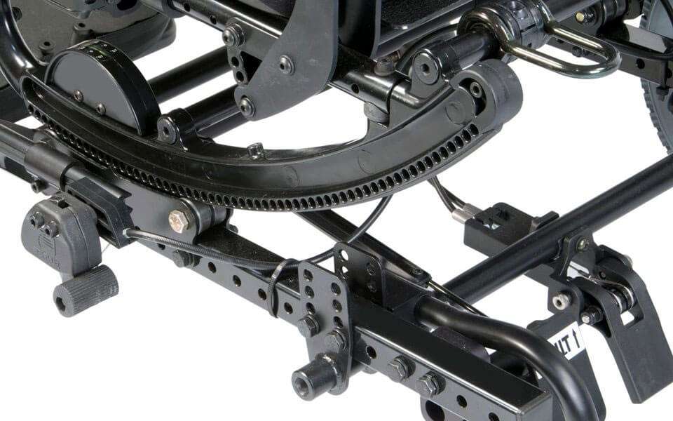 Under the seat: the curved rocker with its row of locking holes, the tilt dial and the foot release pedal
