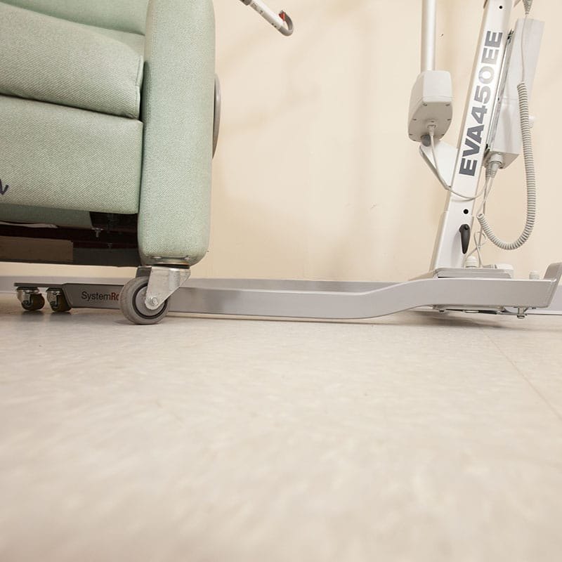 Handicare Eva450EE floor lift in a care room with the mast upright