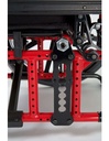 Black axle plate on a red side frame, showing the holes that set rear wheel height