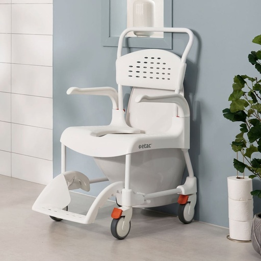 Etac Clean shower commode chair positioned over a wall-mounted toilet, showing the upright push handle