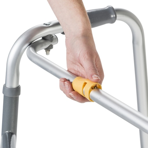 Hand pressing the yellow button on the small silver walker