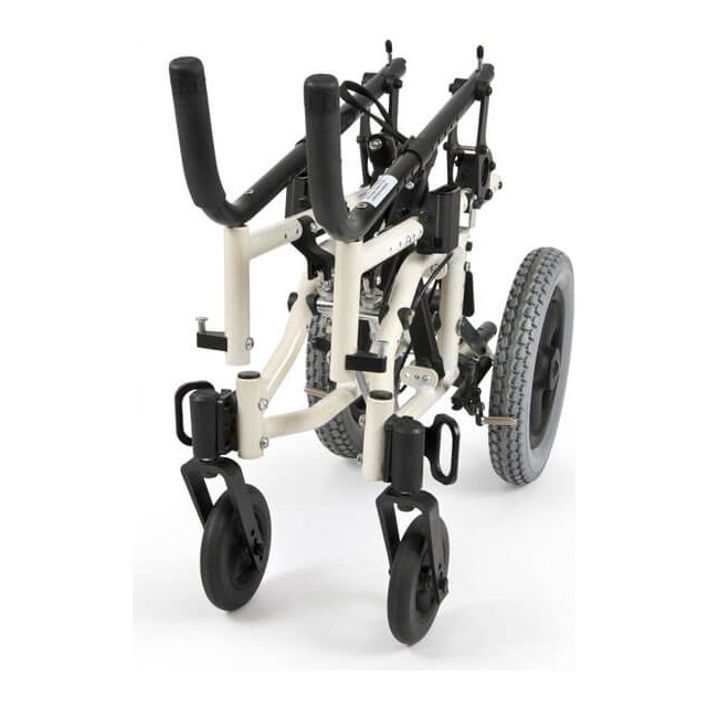 The white TS frame folded, seat and back off, with one rear wheel still mounted