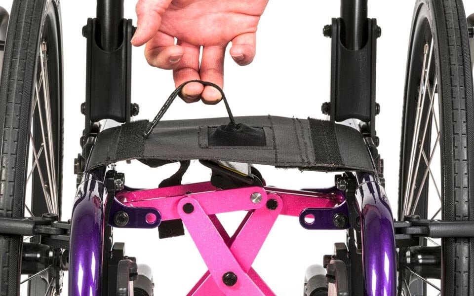 Hand on the fold strap above the pink crossbrace of a ZIPPIE X'CAPE