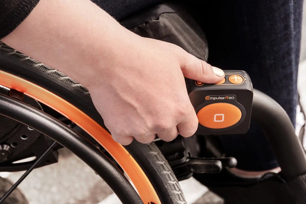 Hand on the Empulse R90 control box, plus button and orange mode key