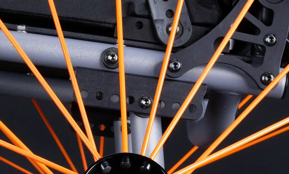 Close view of the Match Point axle plate, with orange spokes in front