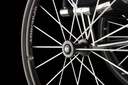 Close view of the axle tube, spokes and Sub4 rim on an RGK Octane wheelchair