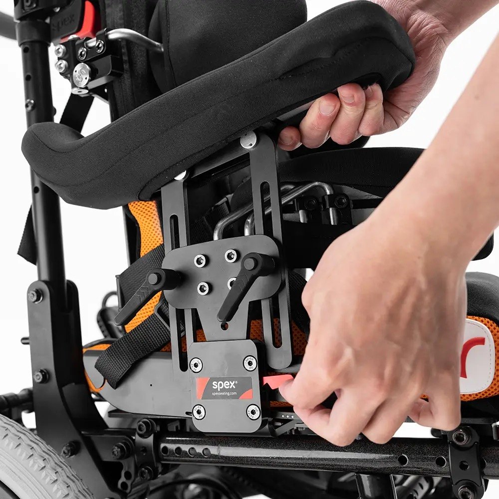 Hands adjusting the mechanism on the side of the Spex Wonderseat