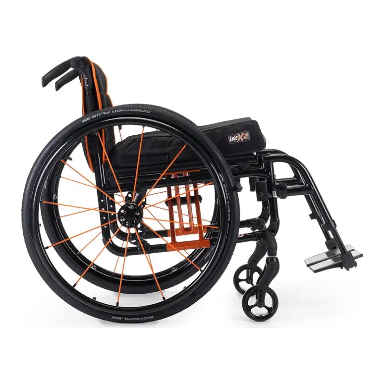 Quickie QS5 X folding wheelchair in orange seen from the front at an angle, with a JAY X2 cushion