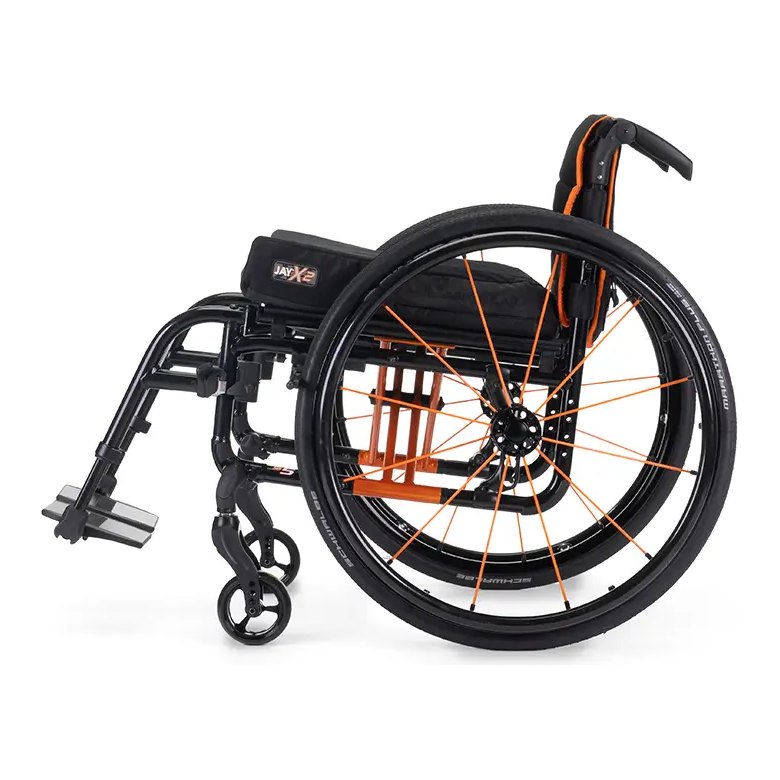 Quickie QS5 X ultralight folding wheelchair seen from the rear at an angle, orange frame and black wheels