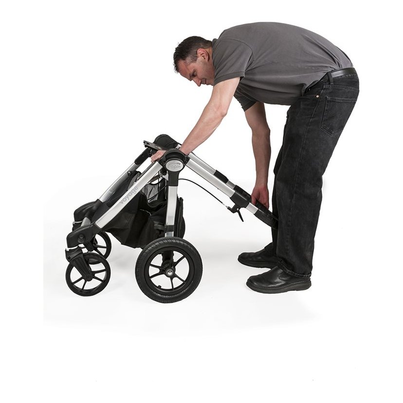 Caregiver folding the Zippie Voyage base after the seating system is removed