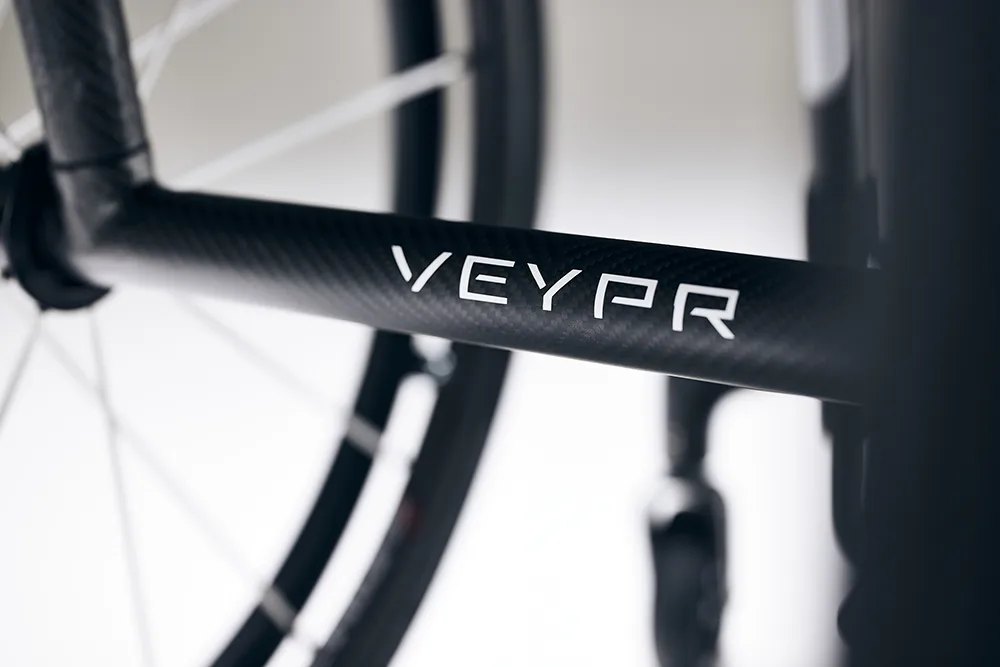 Close view of the VEYPR name laid into the carbon fibre frame of a Veypr Sub4 chair