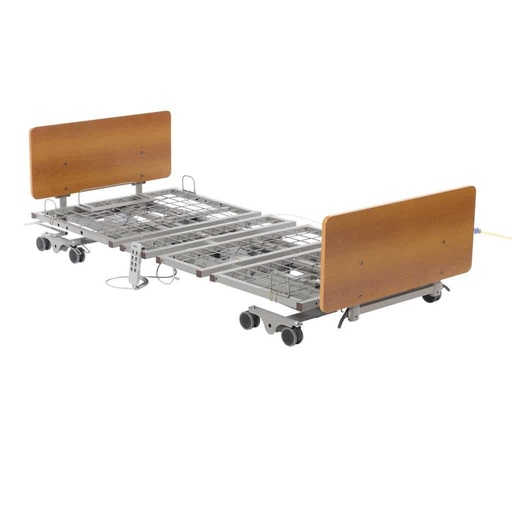 PrimeCare P503 long term care bed frame with grid sleep deck, oak bed ends and grey casters