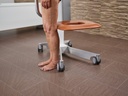 The Eve lift seat at its lowest with a resident standing beside it, showing the low step-on height