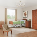 Prestige Collection resident room with wardrobe, chest, bedside cabinet and overbed table beside the bed