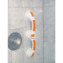 The rotating grab bar pressed onto a tiled shower wall beside the taps