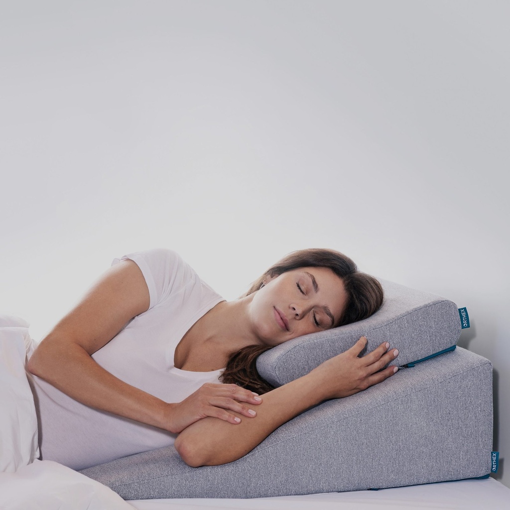 The Orthex Symbia back wedge in the low 16 degree size, set up on a bed