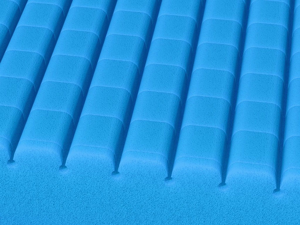 Close view of the blue Geo-Mattress UltraMax top, rows of raised foam cells.