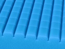 Close view of the blue Geo-Mattress UltraMax top, rows of raised foam cells.