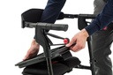 Hands pressing the neXus tray onto the seat of a rollator